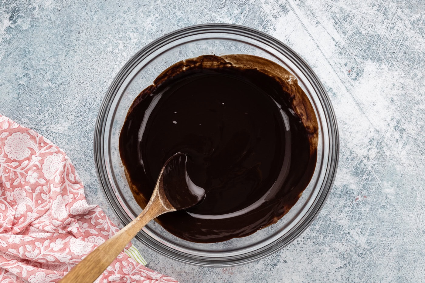 melted chocolate in a bowl with a wooden spoon