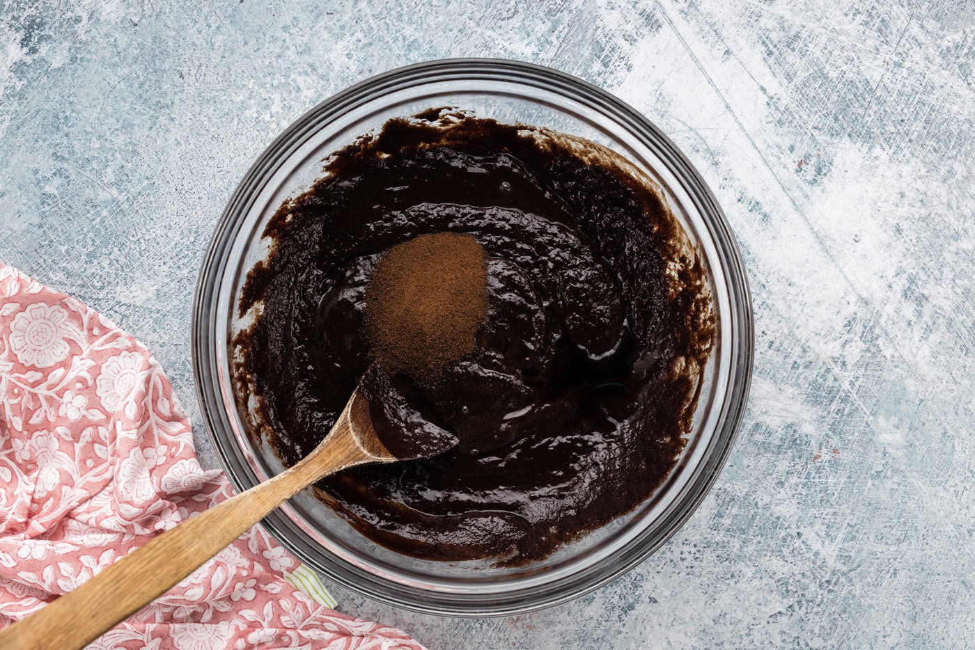 espresso powder added to bowl of brownie batter