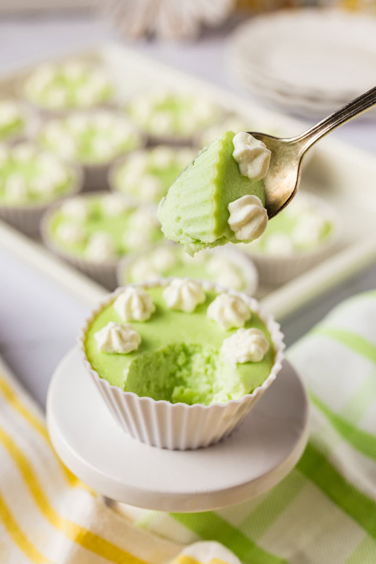 Spoonful of Keto Lime Cheesecake held above a cheesecake bite