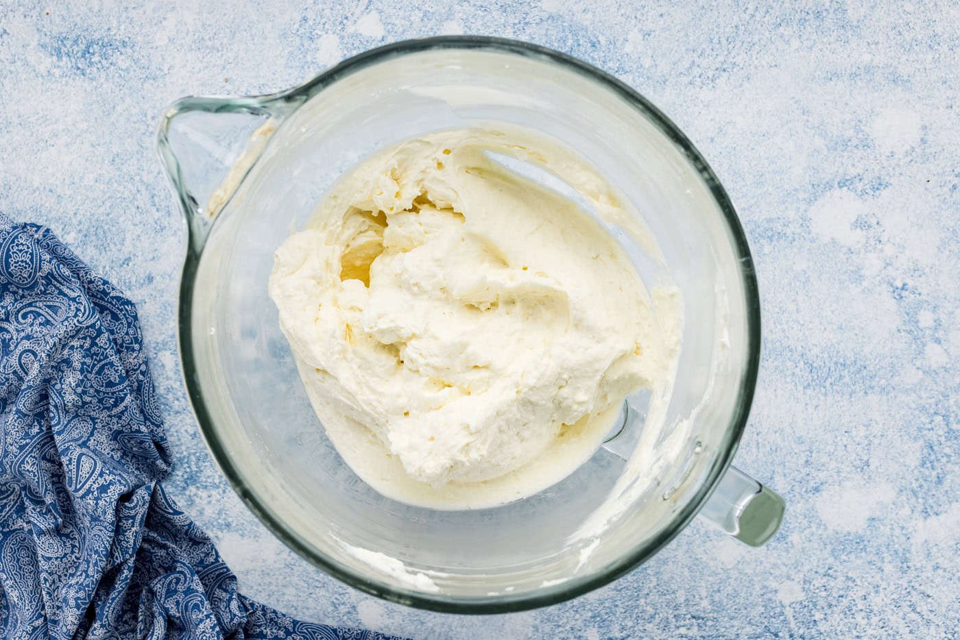 cream cheese, butter, and sugar mixture in a bowl of a stand mixer