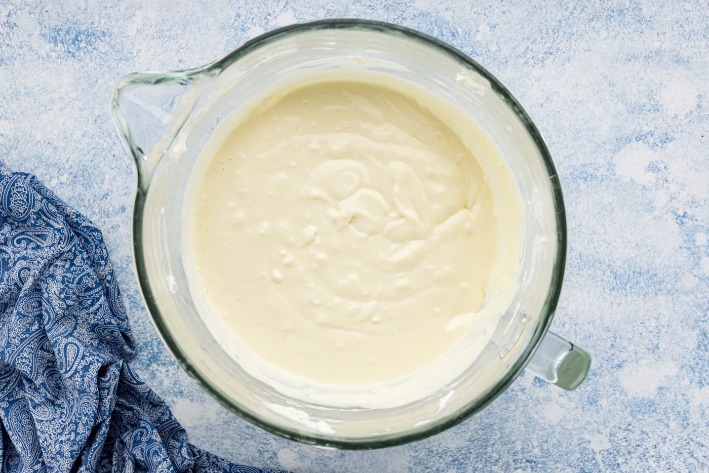 cheesecake batter in the bowl of a stand mixer