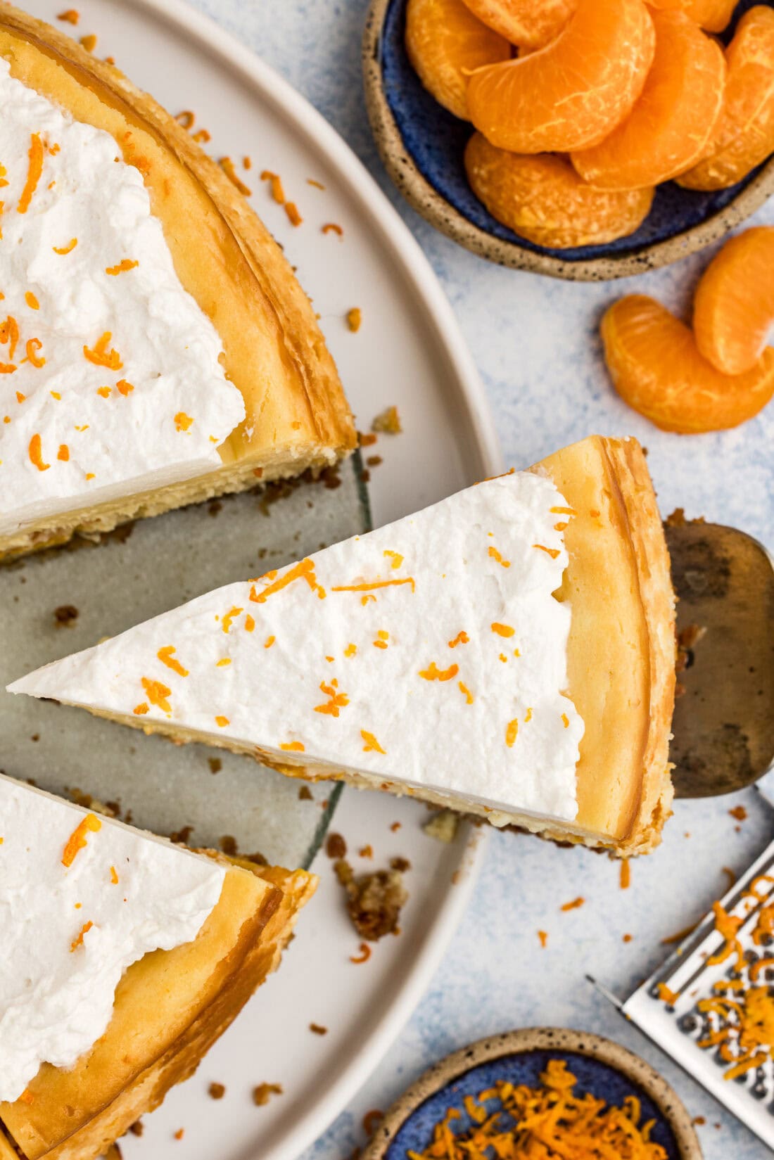 Slice of Mandarin Orange Cheesecake being removed from the cheesecake