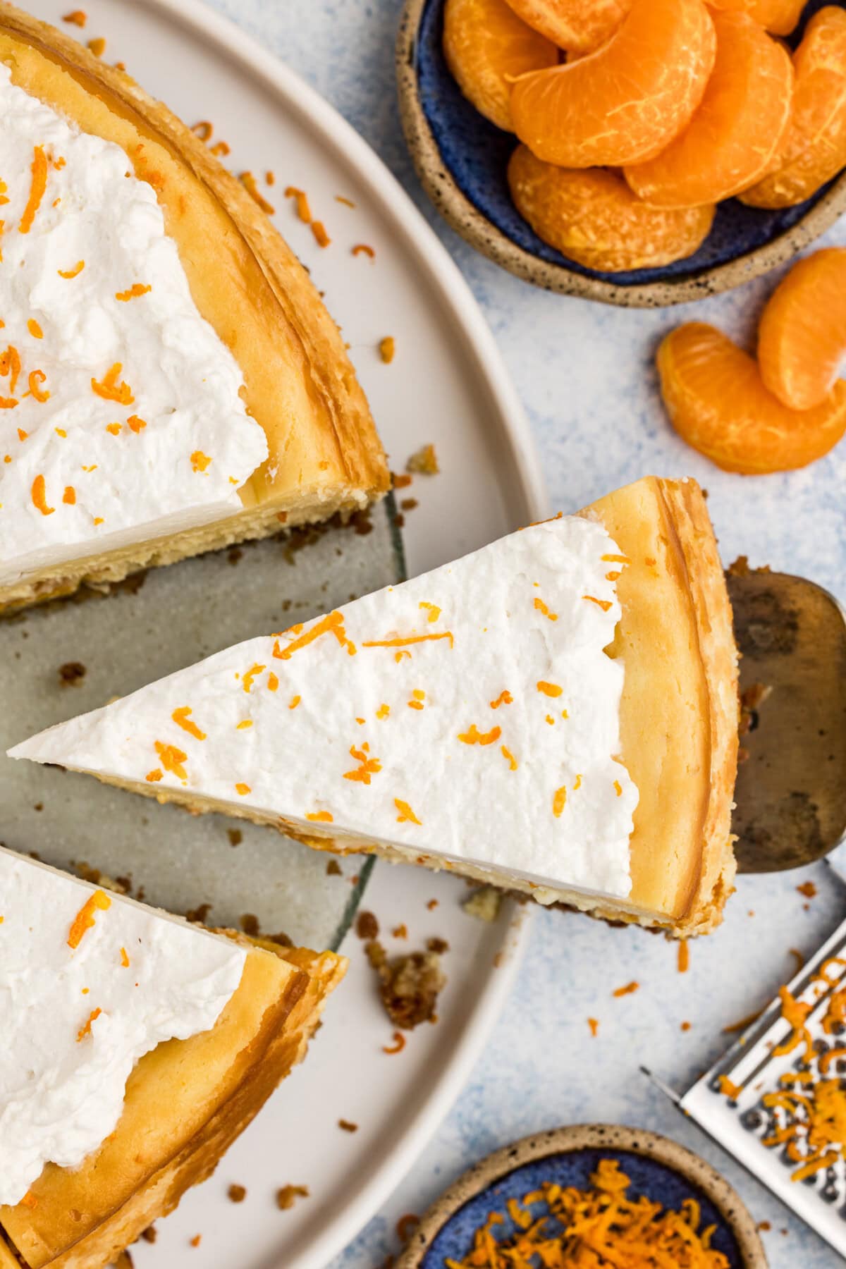Slice of Mandarin Orange Cheesecake being removed from the cheesecake