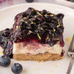 Close up photo of a slice of No Bake Blueberry Cheesecake on a plate