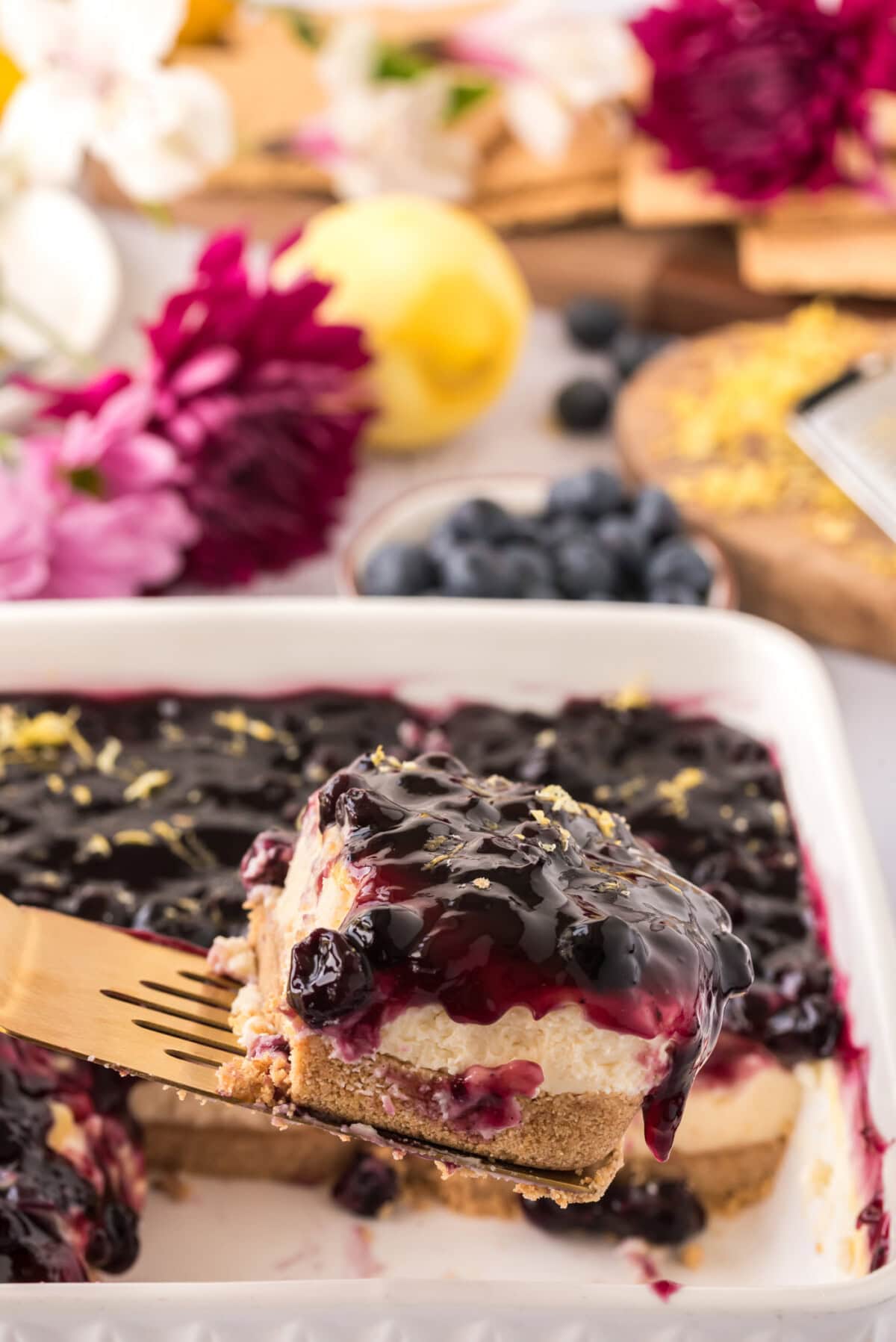 Spatula lifting up a slice of No Bake Blueberry Cheesecake