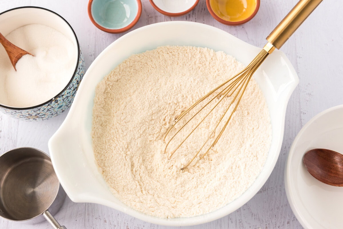 flour, sugar, baking powder, baking soda, and salt whisked in a bowl