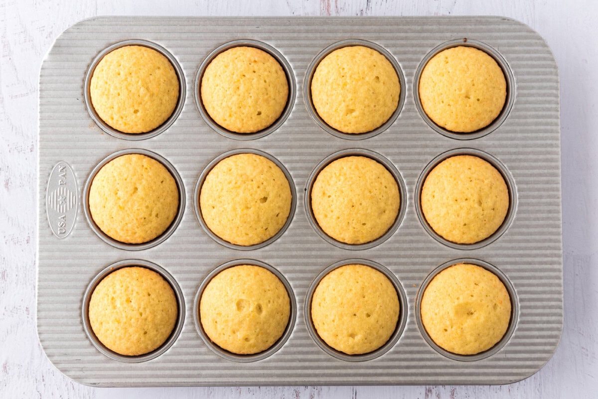 baked orange creamsicle cupcakes in a pan