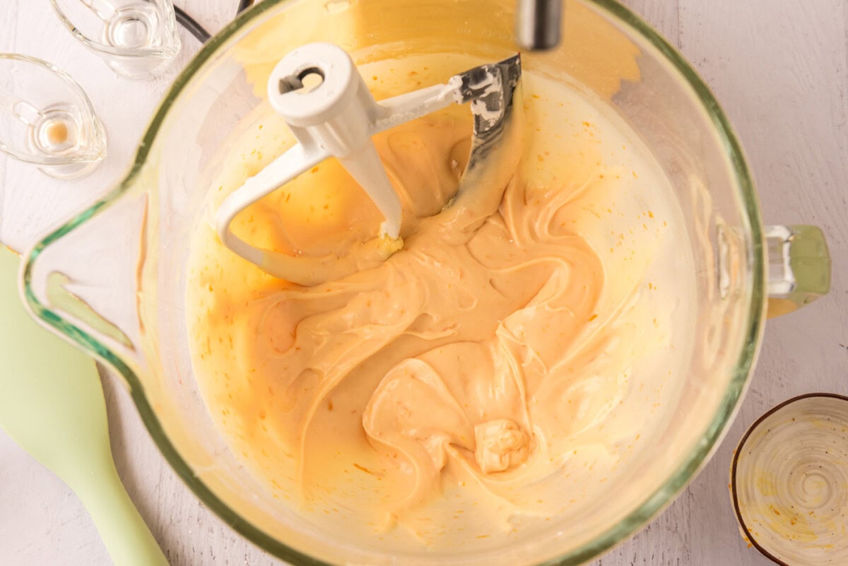 orange creamsicle frosting in a stand mixer bowl