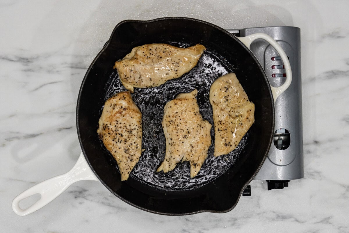 cooked chicken breasts seared in a skillet