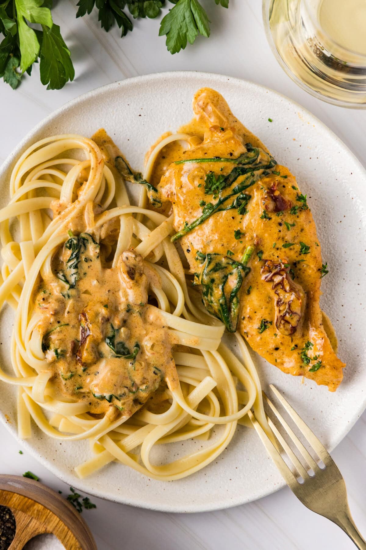 Tuscan Chicken on a plate with noodles