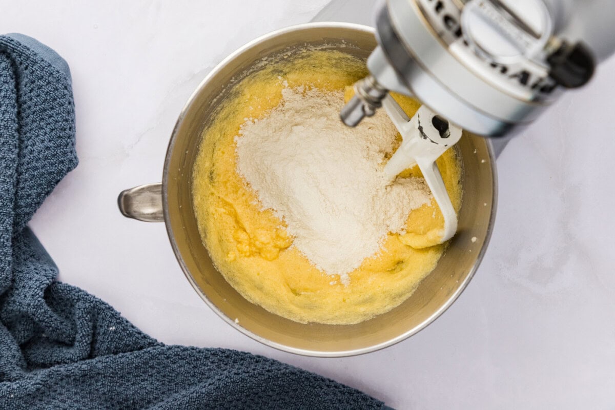 flour mixture added to butter and sugar mixture in a stand mixer bowl