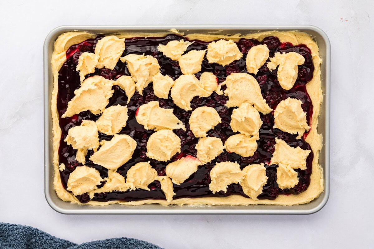 dollops of cookie dough batter on top of blackberry pie filling