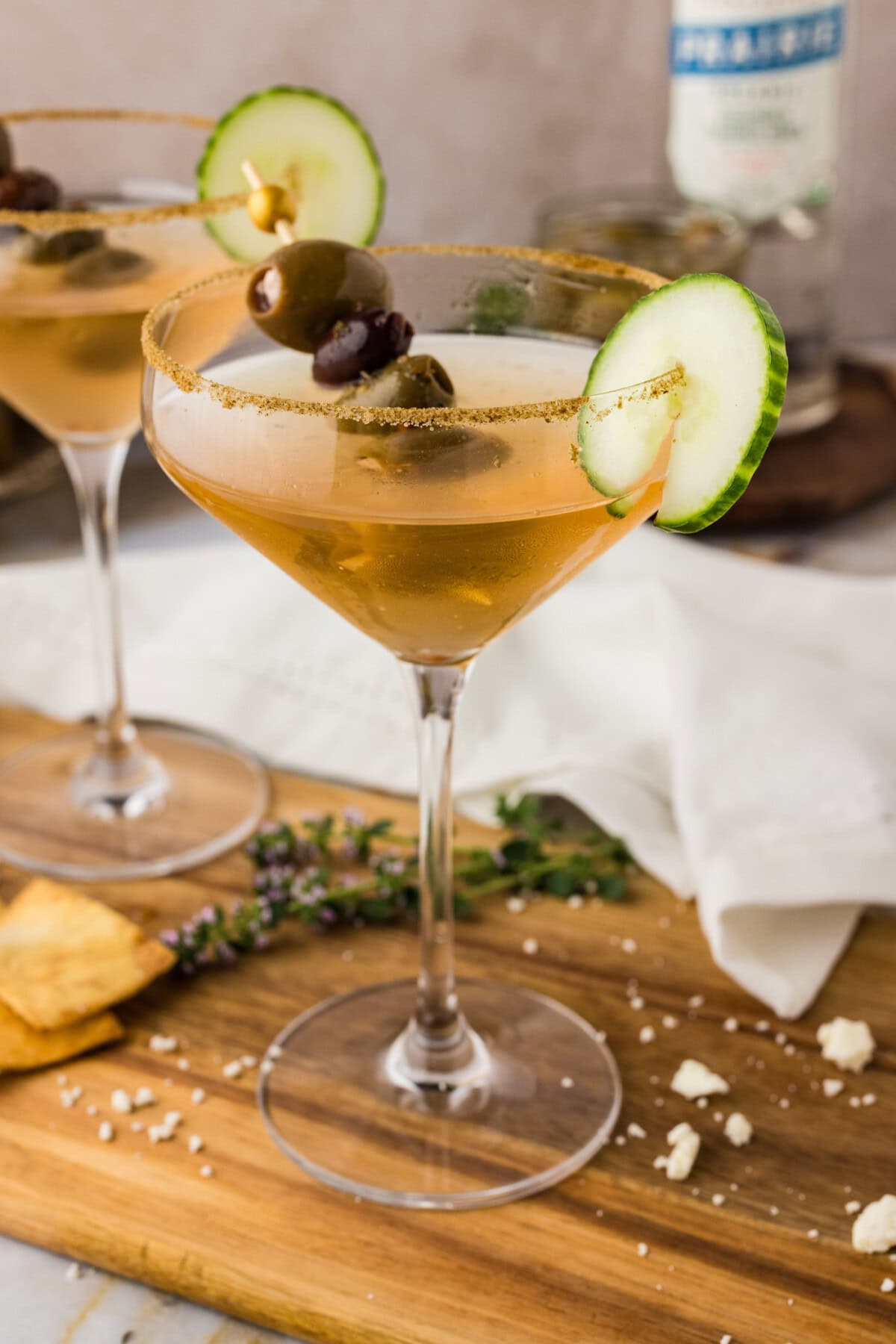 Close up photo of a Dirty Greek Martini on a wooden board