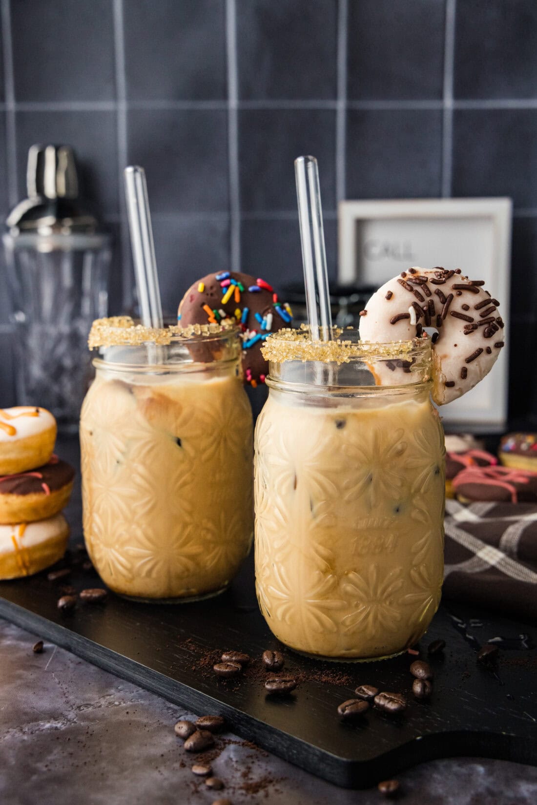 Two Iced Espresso Cocktails garnished with mini donuts
