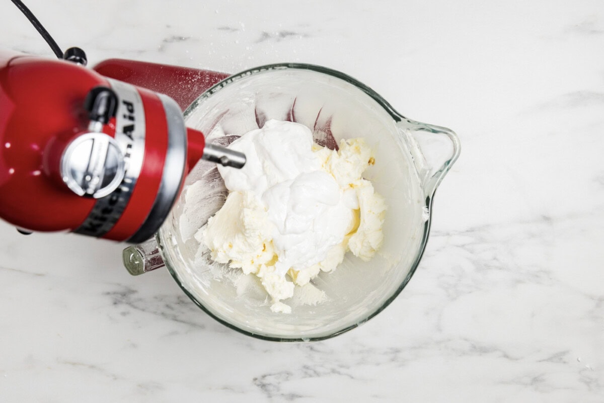 marshmallow fluff added to butter and sugar mixture in a bowl