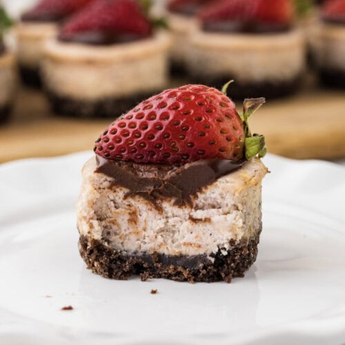 Close up photo of a Mini Strawberry Cheesecake with a bite removed