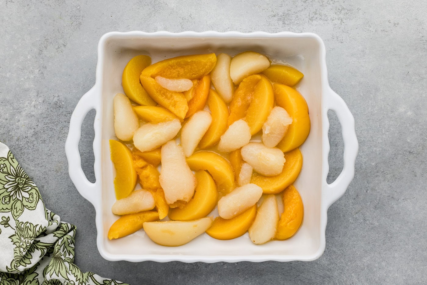 drained canned peaches and pears in a baking dish