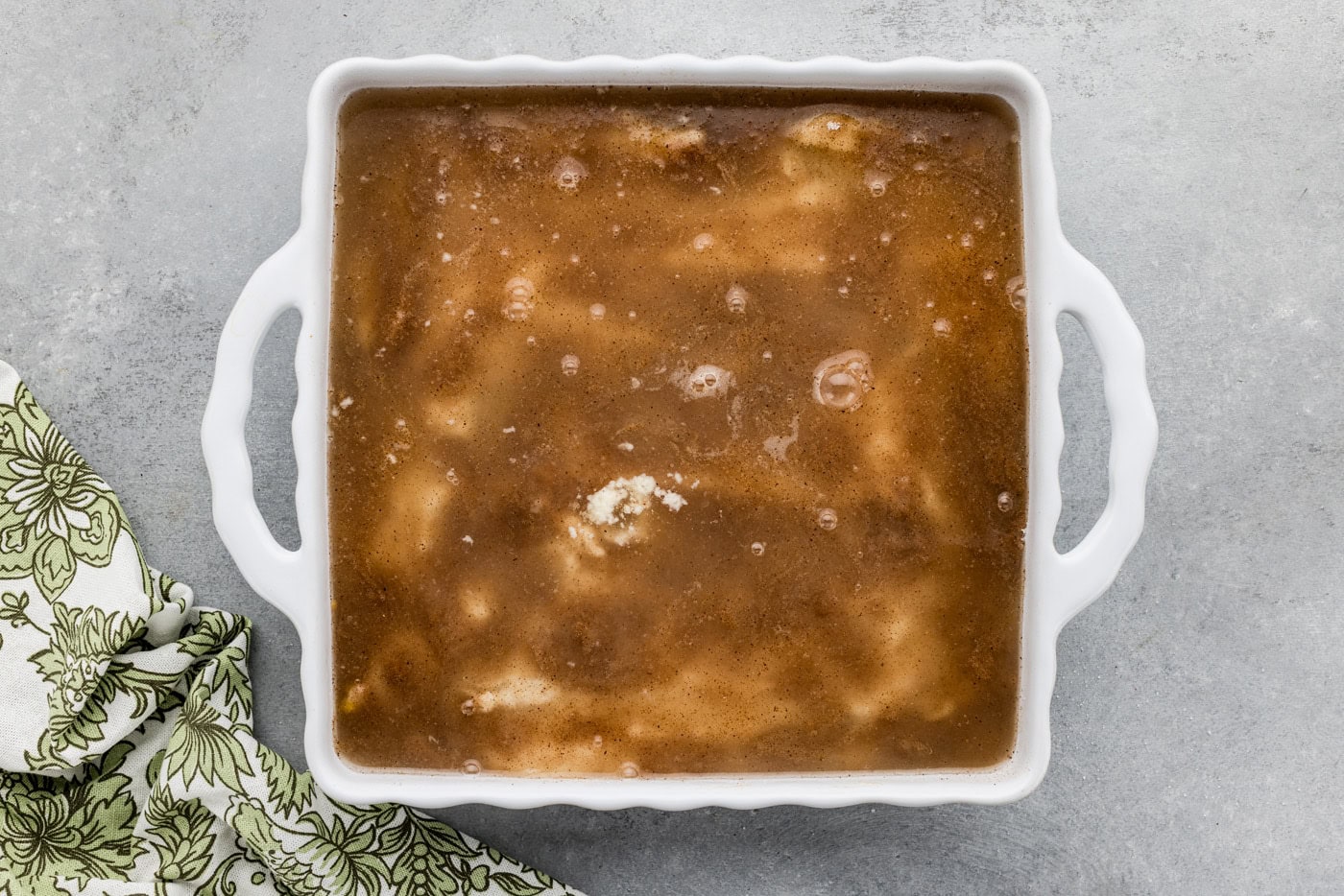 overhead of pear peach cobbler mixture in a baking dish