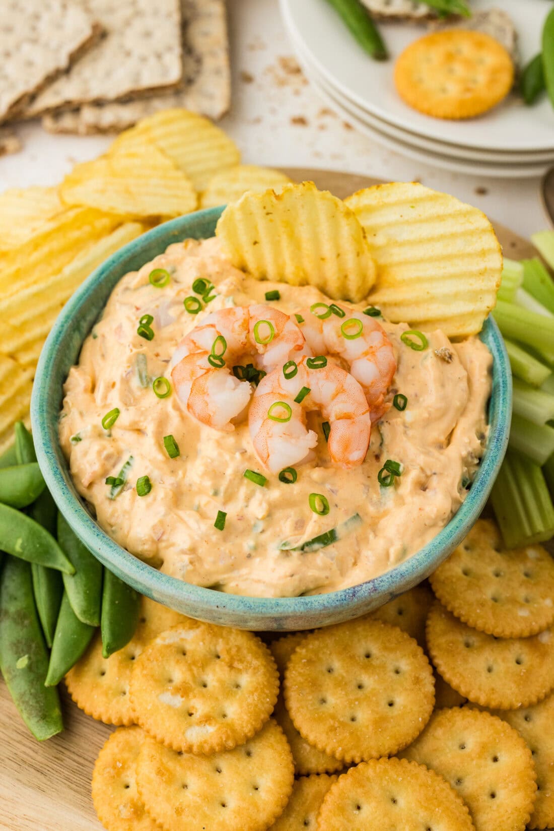 Close up photo of a bowl of Shrimp Dip with two chips in it