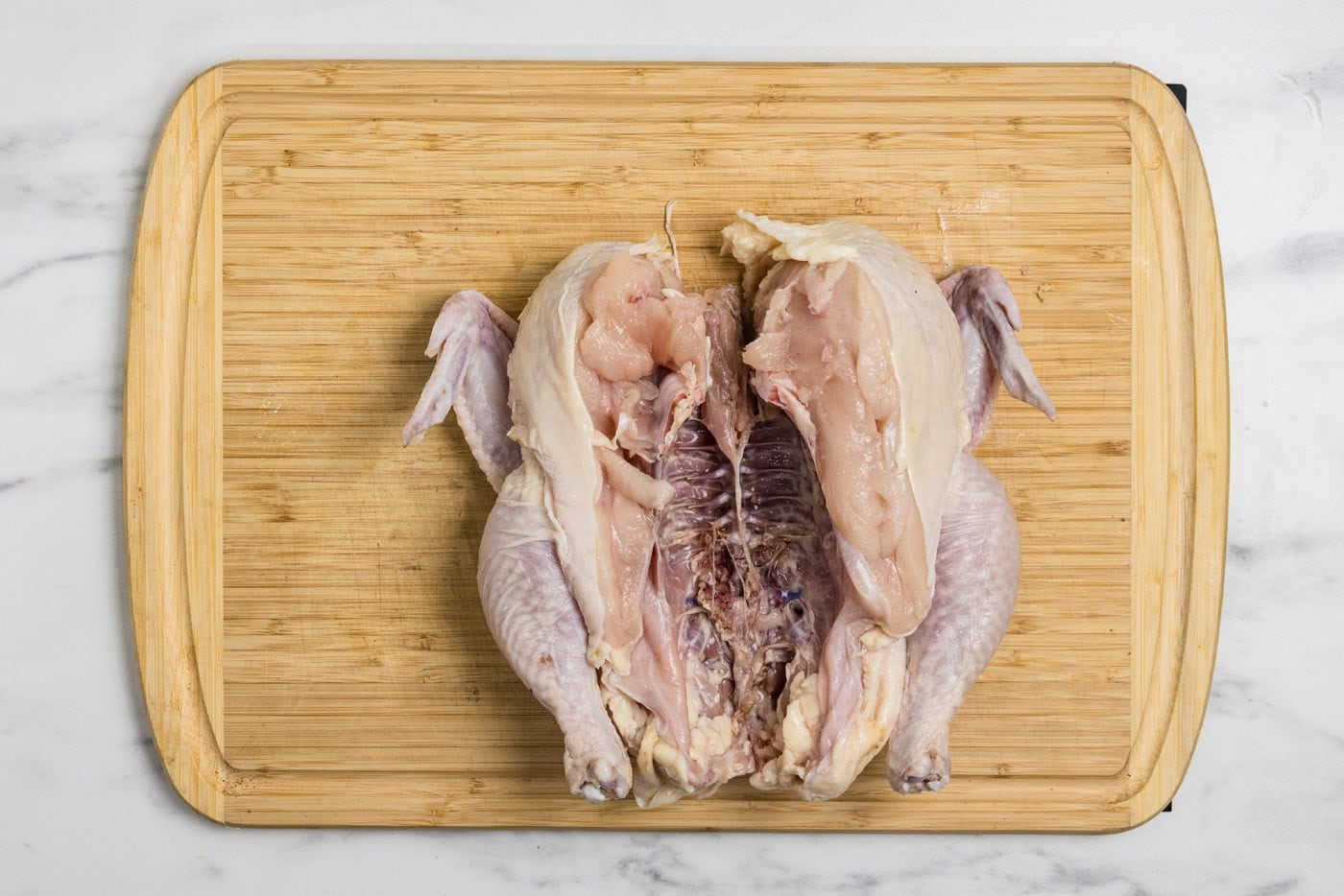 spatchcocked chicken on a cutting board