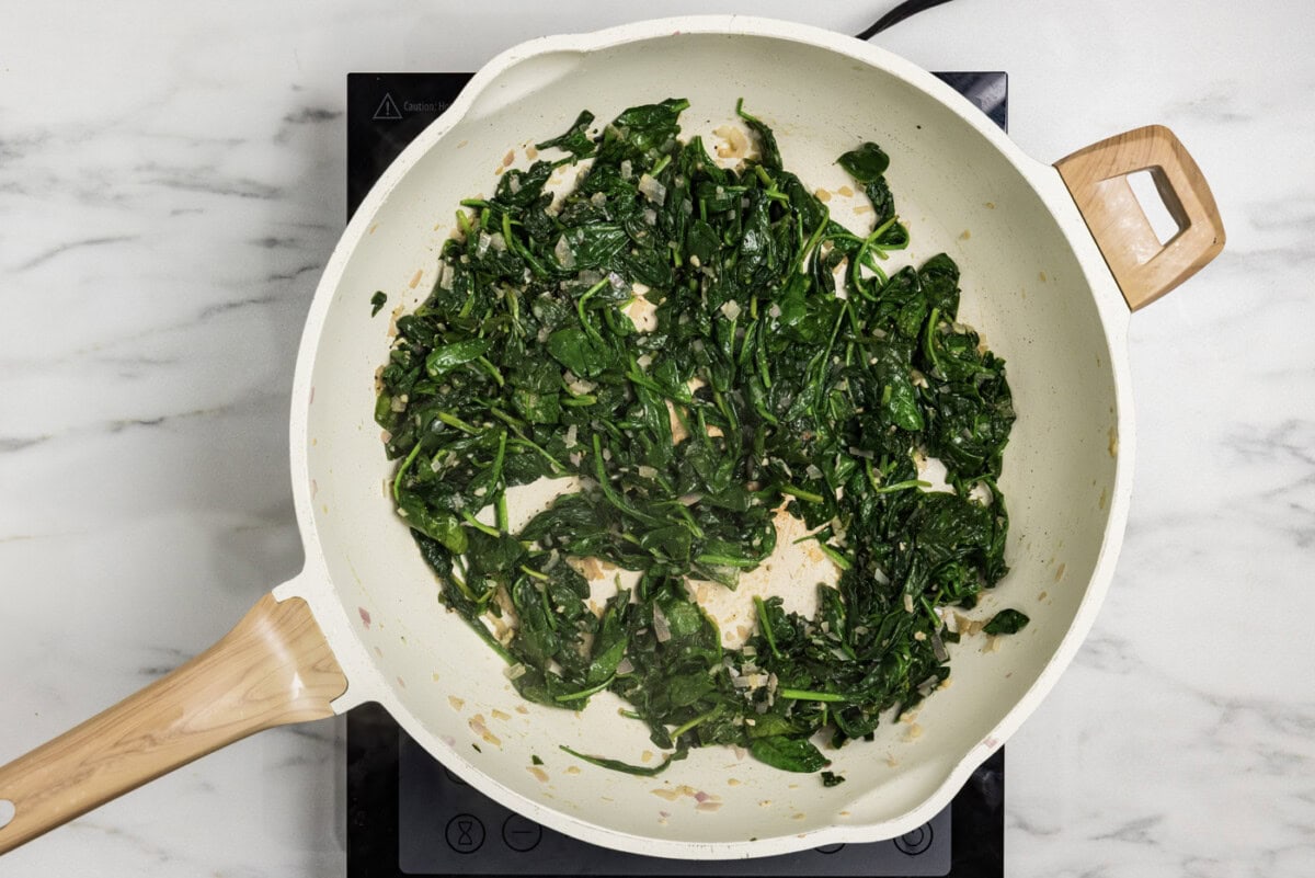 sauteed spinach mixture in a skillet