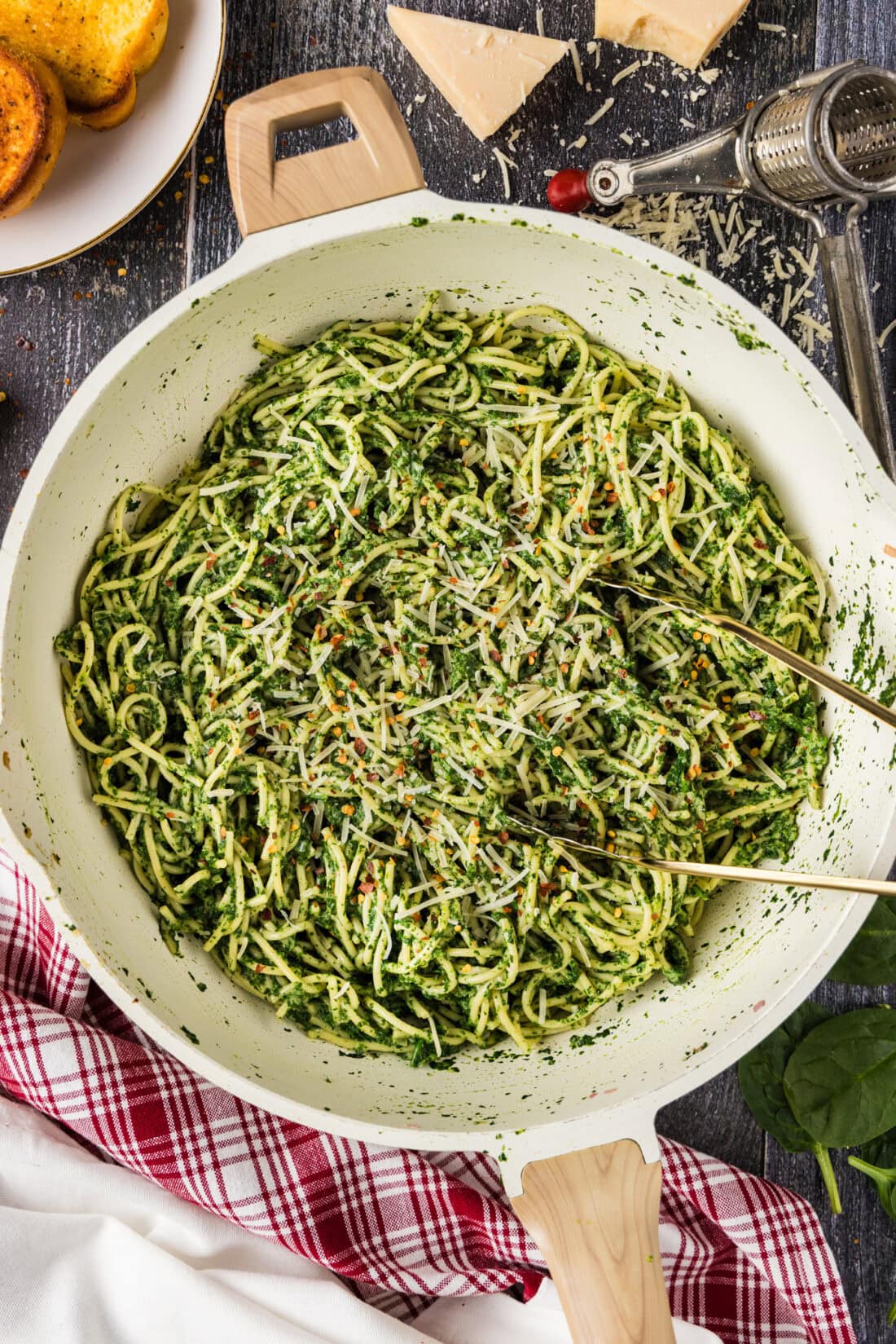 Skillet of Spinach Spaghetti with tongs in it