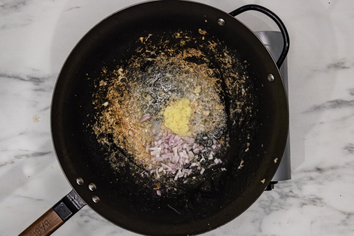 garlic, ginger, and shallots added to a wok