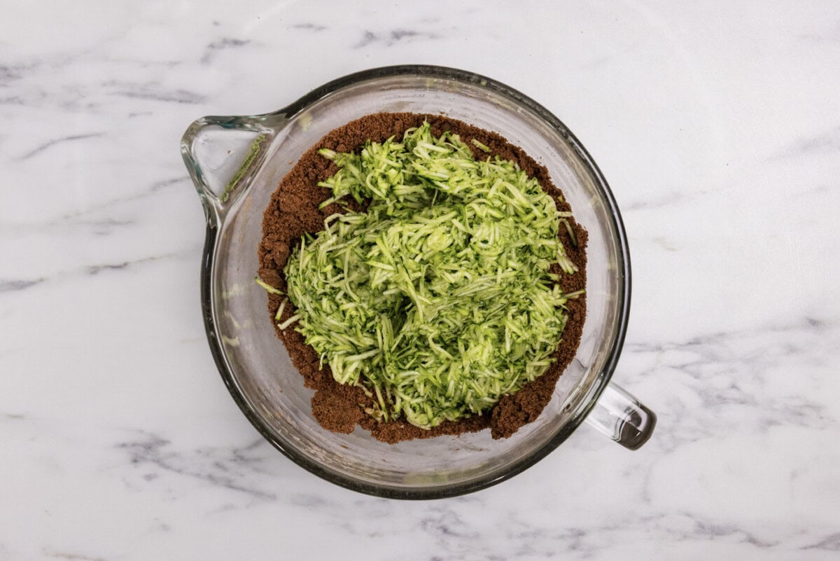shredded zucchini added to bowl with brownie mixture