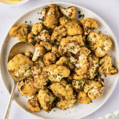 Plate of Air Fryer Cauliflower with a serving spoon on the side