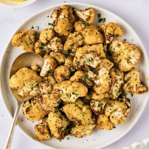 Plate of Air Fryer Cauliflower with a serving spoon on the side