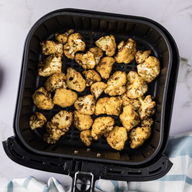 Close up photo of cauliflower in an air fryer basket