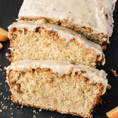 Close up photo of two slices of Apple Cider Pound Cake resting on the loaf