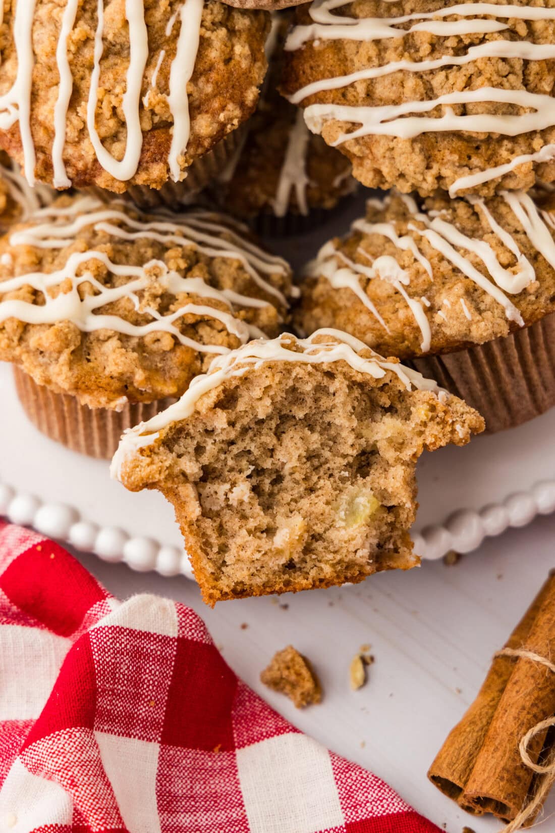 Close up photo of half of a Apple Muffin with more muffins behind it