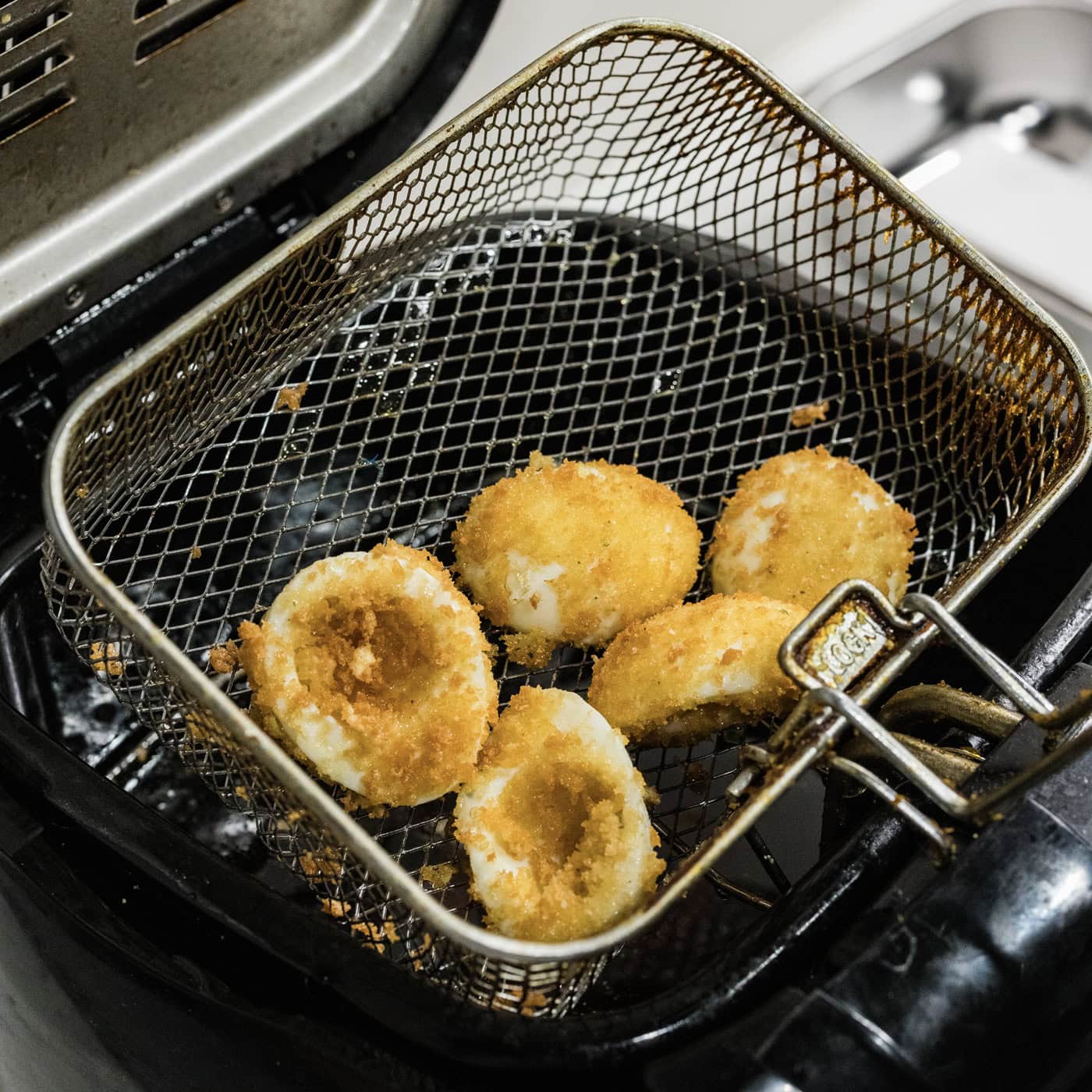 deep fried deviled eggs in a fryer basket