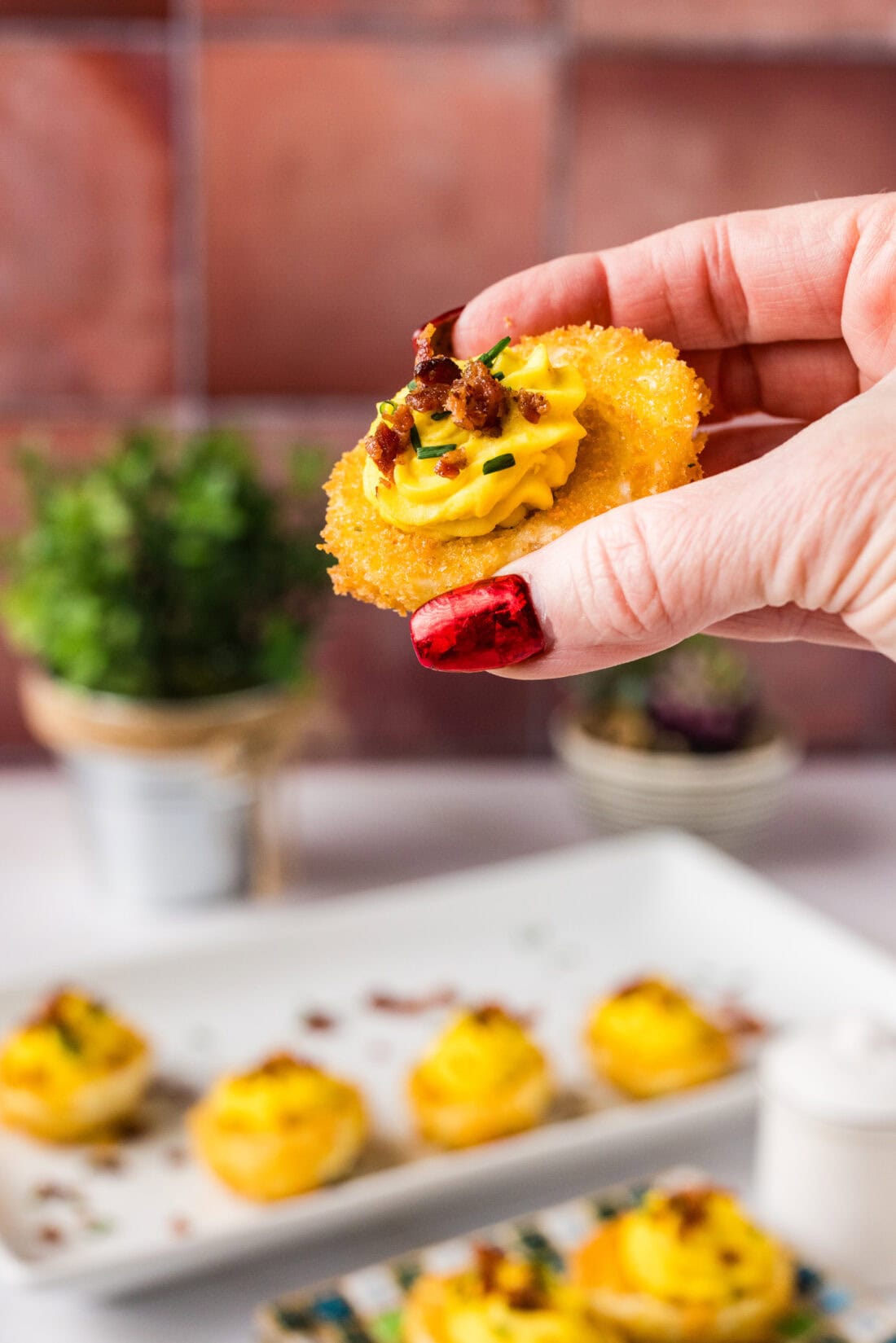 Hand holding up a Fried Deviled Egg