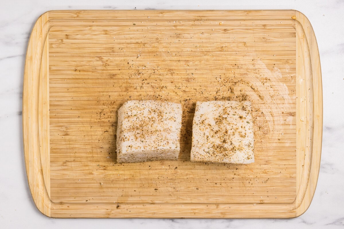 seasoned chilean sea bass filets on a cutting board