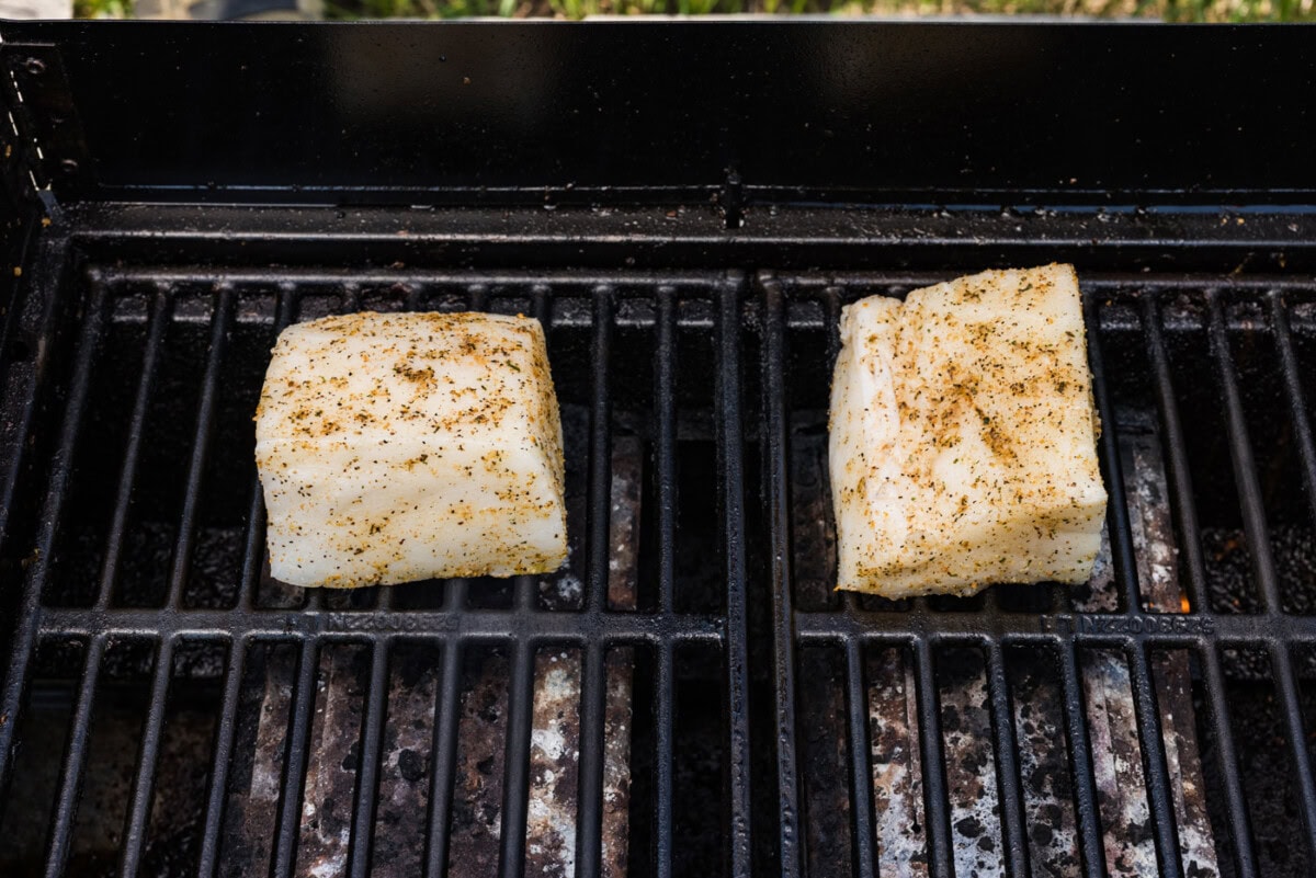 Seasoned chilean sea bass filets on hot grill grates