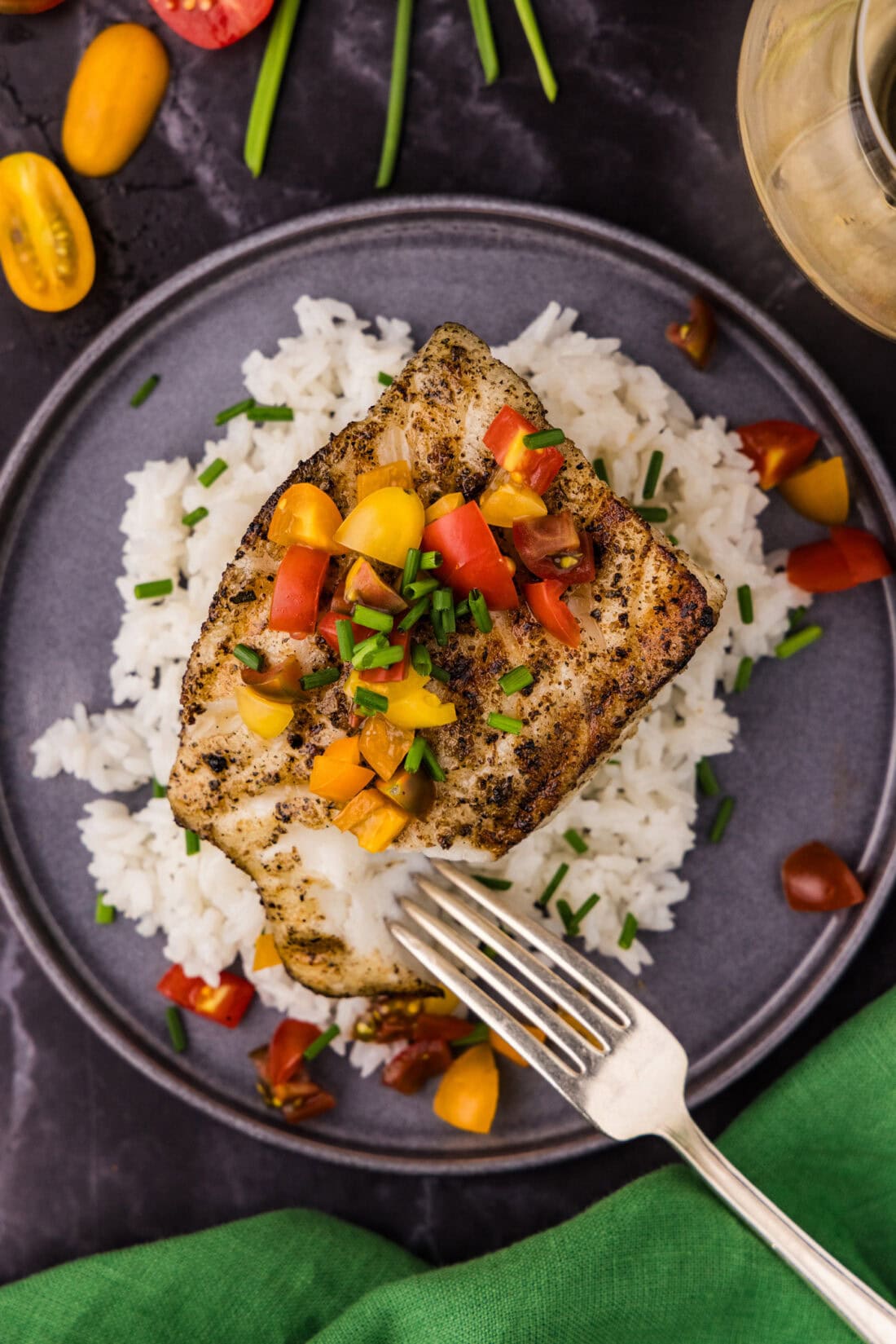 Overhead photo of Grilled Chilean Sea Bass resting over white rice on a plate