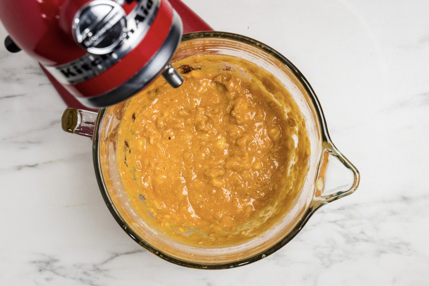 pumpkin, spices, and butter mixture in a stand mixer bowl