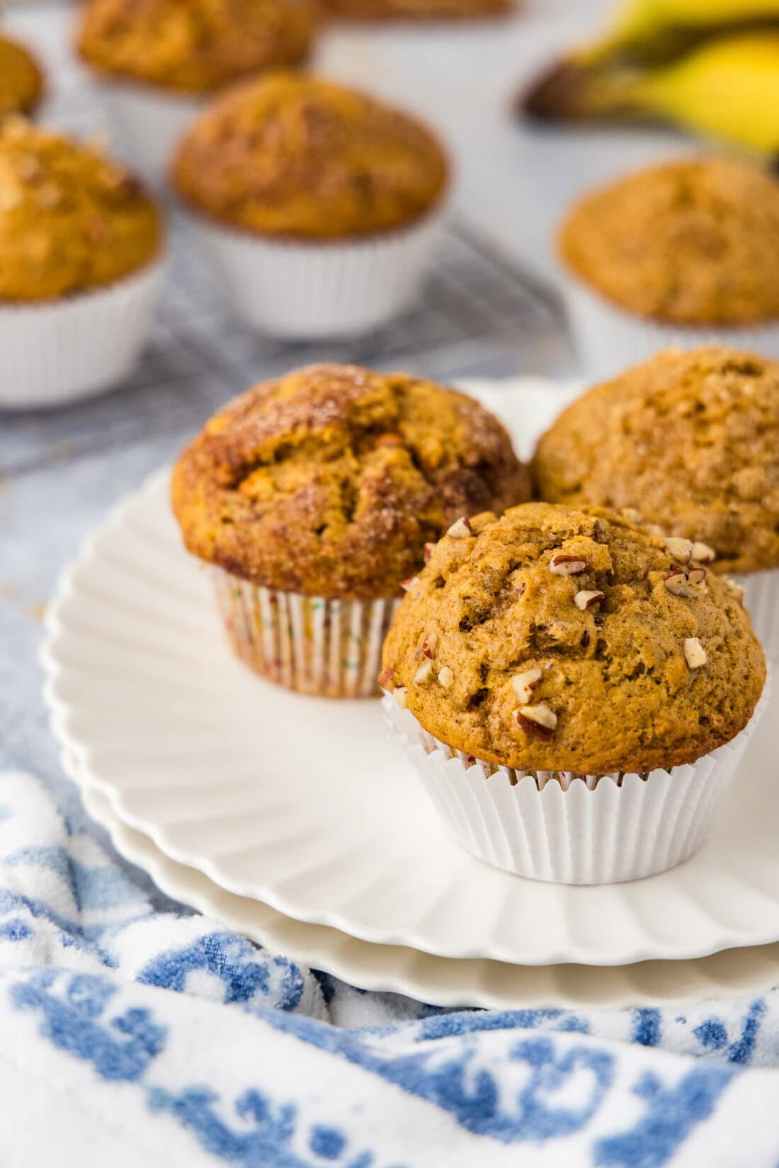 Three Pumpkin Banana Muffins on a wire rack