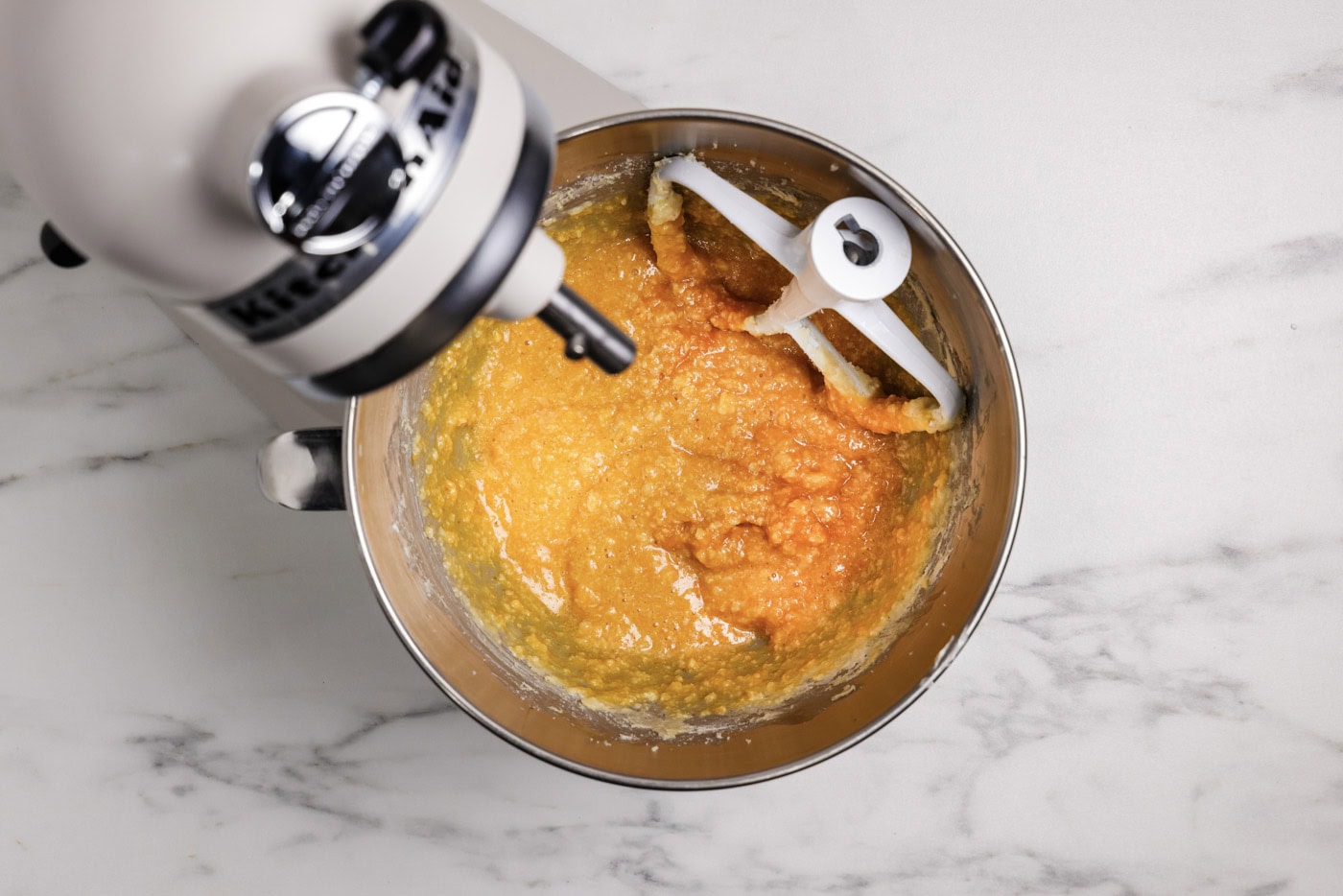 pumpkin and butter mixture in a stand mixer bowl