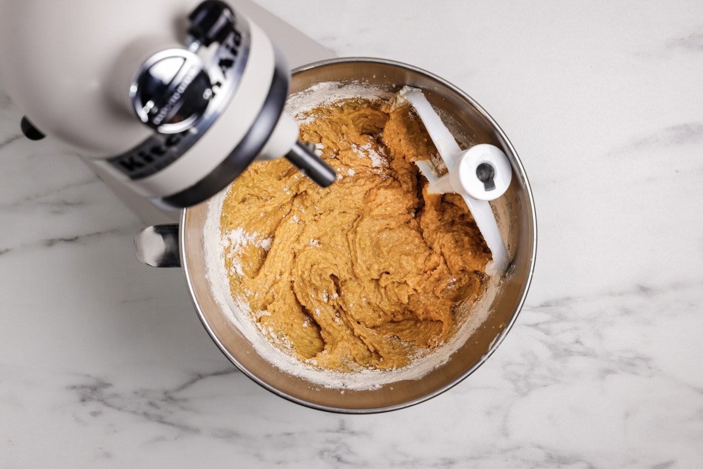 pumpkin muffins batter in a stand mixer bowl