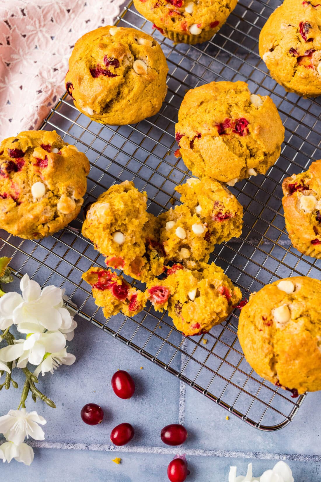 Pumpkin Cranberry Muffin broken apart on a wire rack