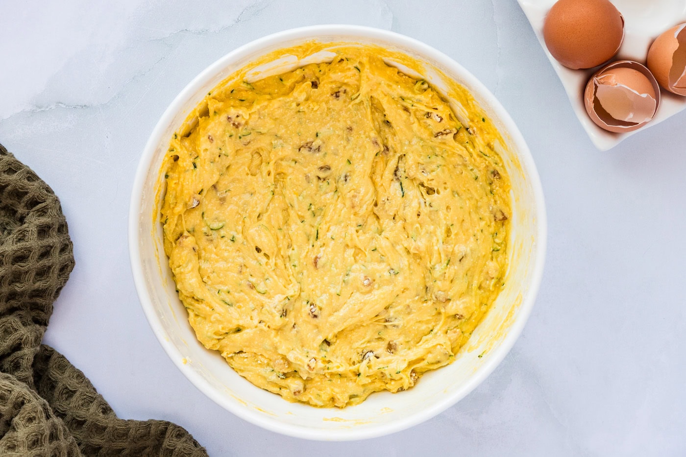 zucchini muffin batter in a mixing bowl