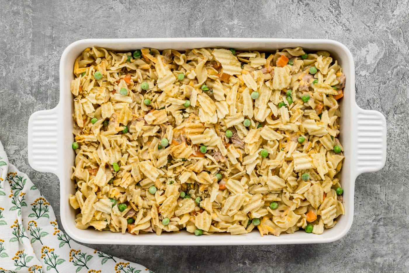 crushed potato chips on top of tuna casserole in a baking dish