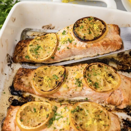 Baked Lemon Salmon filet being lifted out of the pan