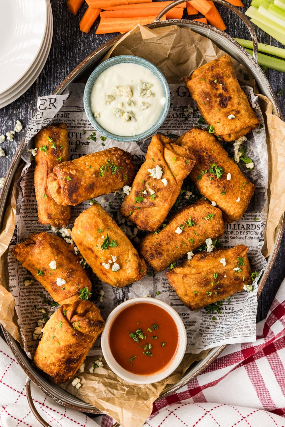 Platter of Buffalo Chicken Egg Rolls with bowls of blue cheese dressing and buffalo sauce
