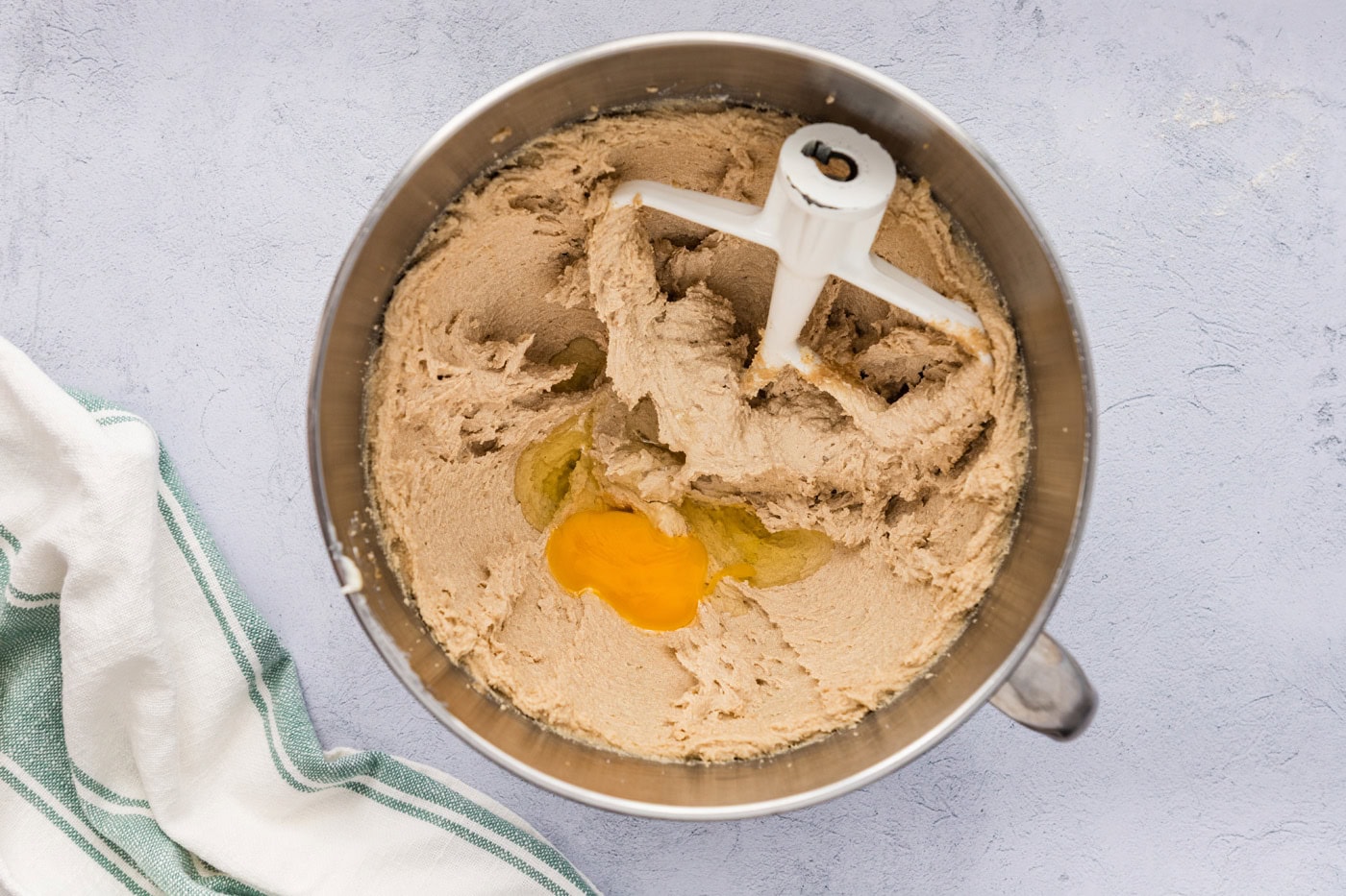 eggs added to creamed butter and sugar mixture in a stand mixer bowl