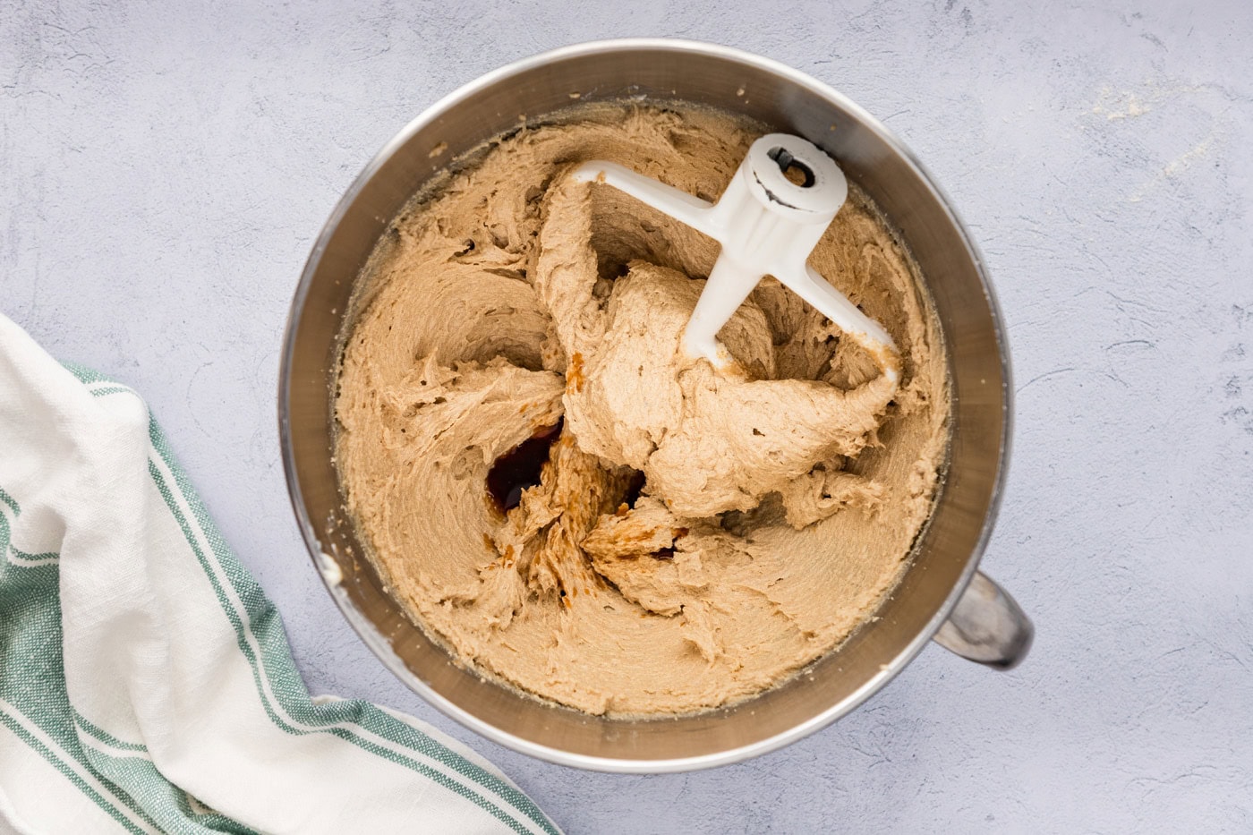 vanilla extract added to creamed butter and sugar mixture in a stand mixer bowl
