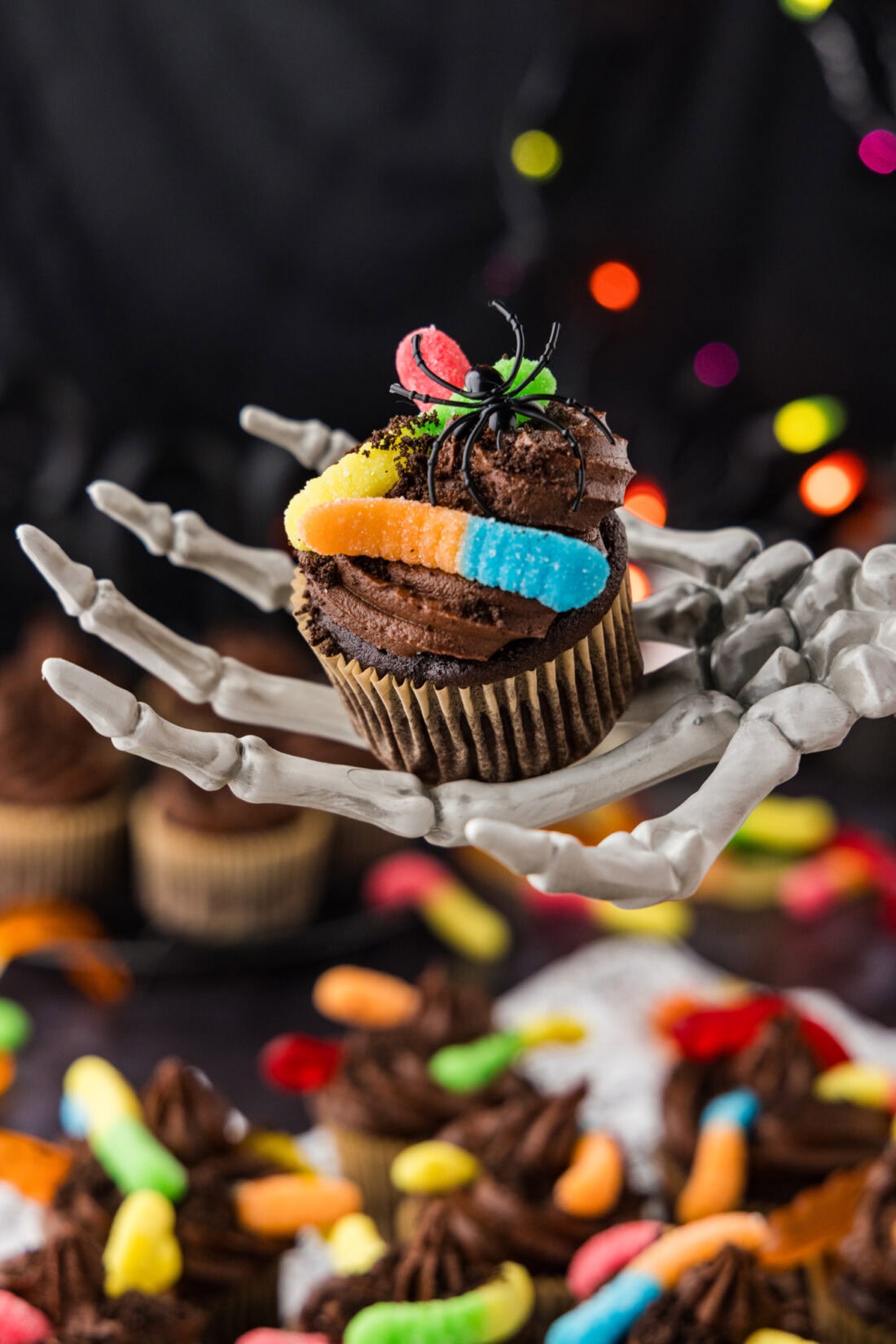 Skeleton hand holding a Halloween Dirt Cupcake